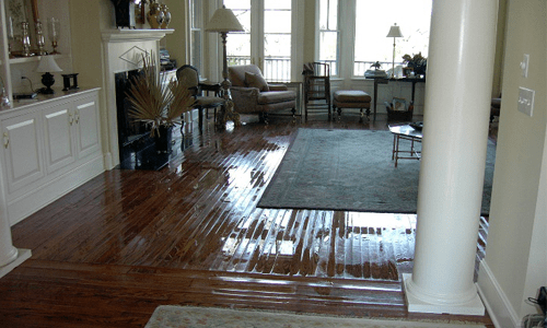 Wet hardwood floor in elegant living room.